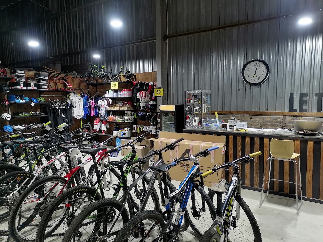 Bicycles, clothing and accessories on the floor at Le Tour Cycles